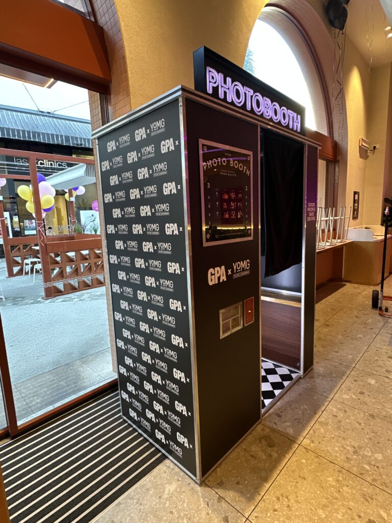 Retro enclosed photo booth fully vinyl-wrapped for YOMG x GPA brand activation at Pacific Fair shopping centre
